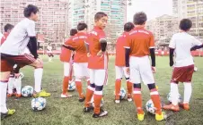  ??  ?? File photo shows Chinese youth wearing Bayern Munich jerseys, take part in a training session.