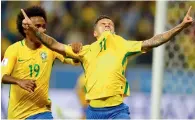  ??  ?? Philippe Coutinho celebrates his goal against Ecuador with teammate Willian during a World Cup qualifier.