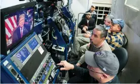  ??  ?? TV staff watch from the press briefing room as Donald Trump delivers his address to the nation Photograph: Shawn Thew/EPA