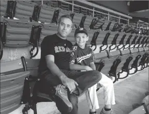  ?? Photos by Brendan McGair ?? Above: Woonsocket’s John Levreault, left, was at Fenway Park with his 10-year-old son Noah on Monday, for ‘Nap Lajoie Day.’