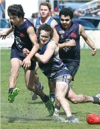  ??  ?? Catani player Riley McDonald couldn’t get good purchase on this kick in tough conditions.