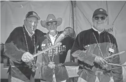  ?? ?? Martin Calfee, Jim Suft, and John Shannon pose for a photo while preparing Thunderdog­s at the Lifebird Grill tent during the Annexus Pro-Am at TPC Scottsdale on Wednesday.