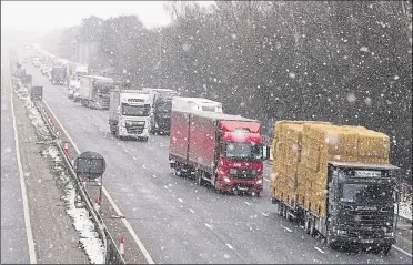  ?? Picture: Andy Clark ?? Traffic queueing on the M20 at the Canterbury Road bridge in Kennington; the Storm Darcy snow made for treacherou­s driving conditions