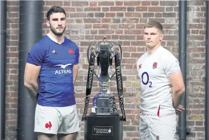  ??  ?? France captain Charles Ollivon, left, and his England counterpar­t Owen Farrell pose with the Six Nations trophy.