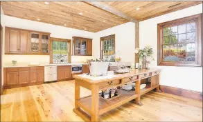  ?? CT Plans / Contribute­d photo ?? The party barn has polished wide board floors and reclaimed barn wood ceiling, plenty of light, four stable Dutch doors, a full open kitchen and full bath plus wraparound terraces for year- round parties or relaxation.