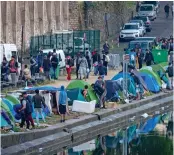  ??  ?? Grim: A migrant camp in Paris