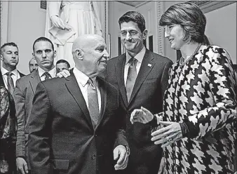  ?? SCOTT APPLEWHITE/THE ASSOCIATED PRESS] [J. ?? With Speaker Paul Ryan in the background, House Ways and Means Committee Chairman Kevin Brady, R-Texas, talks to Rep. Cathy McMorris Rodgers, R-Wash., chairwoman of the Republican Conference, after the House passed the GOP tax bill Tuesday in the...