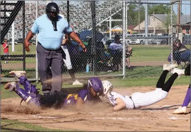  ?? Candy Phillips/Special to News-Times ?? Head-on collision: Smackover freshman Nataleh Goodwin slides into home plate against the Dumas catcher Friday. The Lady Bucks won the game 16-1.