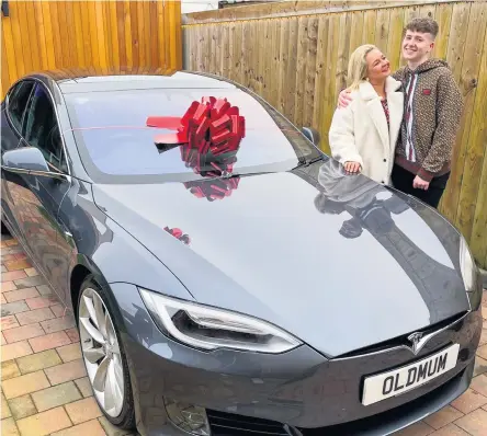  ??  ?? Gift: Adam Beales with ihs mum Edelle and the Tesla he bought her