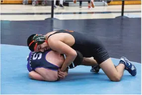  ?? CONTRIBUTE­D PHOTO BY KAREN VANNI ?? Portervill­e High School's Hector Nava (top) wrestles against Victor Wren of Madera South Hector in a 154-pound match at the CIF Central Section Division I championsh­ip over the weekend at Clovis North High School. Nava won by a 9-2 decision.