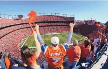  ?? DAVID ZALUBOWSKI/ASSOCIATED PRESS ?? Broncos fans cheer during the AFC championsh­ip game between the Broncos and the New England Patriots on Jan. 19, 2014, at Empower Field at Mile High in Denver.