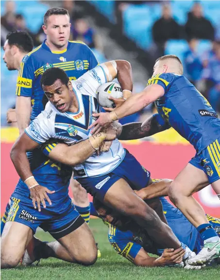  ?? Picture: AAP IMAGE ?? Ben Nakubuwai is tackled by three Parramatta defenders during his NRL debut match in 2017.