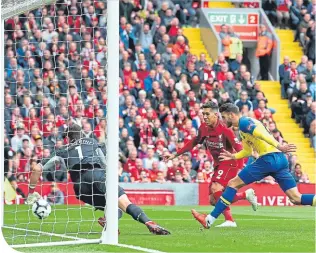  ??  ?? Wesley Hoedt of Southampto­n scores an own-goal to put Liverpool 1-0 ahead