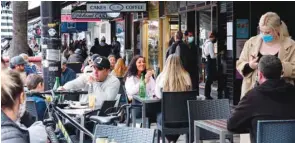  ?? ?? Diners eat outside at a restaurant in Melbourne.