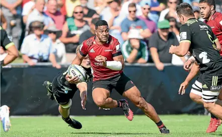  ??  ?? Wing Fetuli Paea makes a charging run for the Crusaders against the Hurricanes in their pre-season clash.