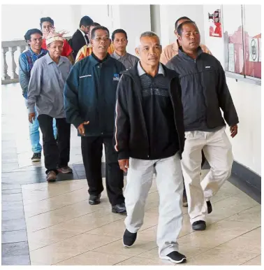  ??  ?? Highland witnesses: A group of orang asli walking to the courtroom for the hearing of the election petition.