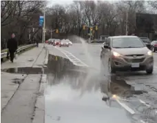  ?? JACK LAKEY ?? A massive puddle stretches across the westbound cycling lane on Bloor St., just west of Parliament St., as well as a swath of sidewalk next to it.