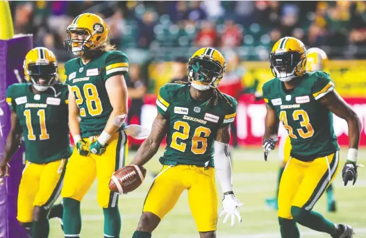  ?? CODIE MCLACHLAN/THE CANADIAN PRESS ?? From left, Edmonton’s Larry Dean, Jordan Hoover, Josh Johnson and Vontae Diggs celebrate the Eskimos’ 16-12 victory over Ottawa on Friday.