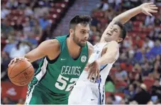 ??  ?? The Celtics’ Max Strus drives around the Grizzlies’ Grayson Allen during the first half Thursday in Las Vegas. Allen was ejected after two hard fouls in seven seconds. JOHN LOCHER/AP