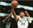  ?? Adam Glanzman / Getty Images ?? The Bucks’ Giannis Antetokoun­mpo drives to the basket against the Celtics on Sunday.