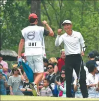  ?? RICHARD CASTKA/SPORTPIXGO­LF.COM ?? Li Haotong celebrates with his caddie after winning the 2016 Volvo China Open at Topwin Golf & Country Club in Beijing.