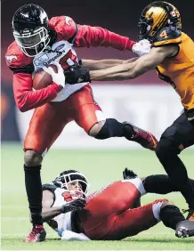  ?? DARRYL DYCK/THE CANADIAN PRESS ?? Calgary Stampeders receiver Bakari Grant, left, had his best game since joining the team late in the season last Saturday against the B.C. Lions, catching a trio of passes.