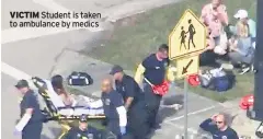  ??  ?? VICTIM Student is taken to ambulance by medics