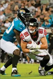  ?? SAM GREENWOOD / GETTY IMAGES ?? Jaguars linebacker Telvin Smith (tackling Falcons tight end Austin Hooper last month) is one of the leaders of a stacked defense. Smith was a fifth-round pick in 2014 and has 447 tackles — more than any other player over the past four seasons.