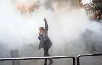  ?? EPA-EFE ?? Iranian students clash Saturday with riot police during an anti-government protest around the University of Tehran.