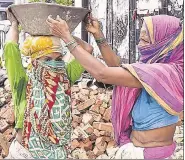  ?? PTI ?? ■
Women work under MGNREGA scheme in Kolkata in June .