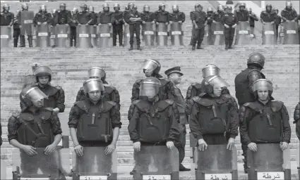  ?? -AFP ?? Police members stand guard during an anti-government protest in Algeria.