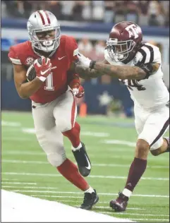  ?? Special to The Sentinel-Record/Craven Whitlow ?? SEASON OVER: Razorback senior wide receiver Jared Cornelius from Shreveport, La., collects a pass for a first down Saturday against Texas A&M in Arlington, Texas. Cornelius caught 3 passes for 35 yards and a touchdown but left the game with a...