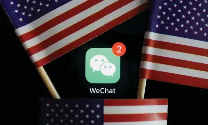  ??  ?? Messenger app WeChat, seen among US flags. Photograph: Florence Lo/Reuters