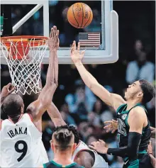  ?? MICHAEL DWYER THE ASSOCIATED PRESS ?? Boston’s Jayson Tatum, right, tosses up a shot against Toronto’s
Serge Ibaka on Saturday. The teams meet again Wednesday in Toronto.