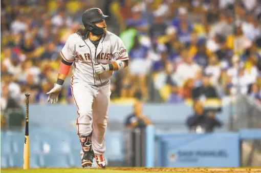  ?? Meg Oliphant / Getty Images ?? Giants shortstop Brandon Crawford hit his longest homer of the season, measured at 444 feet, off Trevor Bauer at Dodger Stadium on Monday.