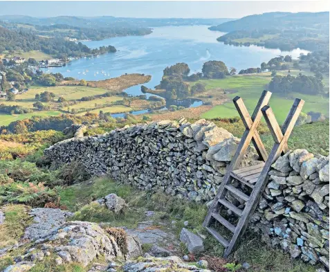  ??  ?? A view of Lake Windermere from Loughrigg Fell, where farmers say environmen­talists have got it wrong in their ‘radical’ vision of the Lake District