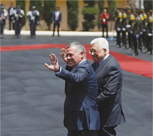  ??  ?? JORDAN’S KING Abdullah II and Palestinia­n President Mahmoud Abbas wave during a reception ceremony in the West Bank city of Ramallah, this week.