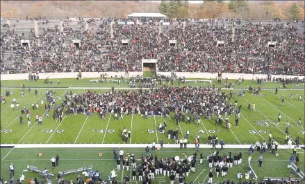  ?? Arnold Gold / Hearst Connecticu­t Media ?? Fans stage a climate change protest at the Yale Bowl delaying the second half of the Yale/Harvard football game in New Haven, on Saturday.