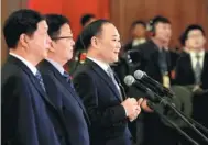  ?? WANG ZHUANGFEI / CHINA DAILY ?? Li Shufu (center), chairman of Zhejiang Geely Holding Group, answers reporters’ queries before the closing meeting of the First Session of the 13th NPC on Tuesday.