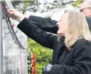  ??  ?? Rememberin­g the fallen . . . In honour of her father, Vicki Smith attended the Armistice Day service in Invercargi­ll yesterday.