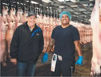  ?? Picture: RENEE NOWYTARGER/THE AUSTRALIAN ?? Cowra Meat Processors general manager Peter Brown with one of his Samoan workers, Harry Ielome