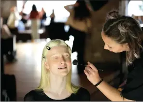  ?? ?? Lucia Della Ratta gets makeup applied Feb. 7 during a photo shoot for L’Imperfetta.