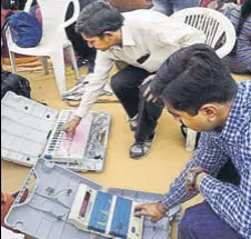  ?? PTI ?? Election Commission officials check the electronic voting machines (EVMS) in Ahmedabad on Wednesday.