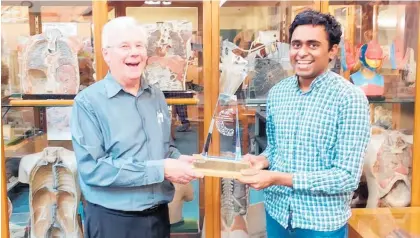  ??  ?? Abhizith Cherukuri receives the Professor Gareth Jones Prize from the man it is named after.