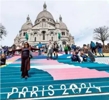  ?? AFP ?? Getting ready: People walk down the stairs painted in the colours of the Paris Olympics in front of the Sacre Coeur Basilica in Paris.