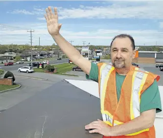  ?? CLIFFORD SKARSTEDT/ EXAMINER ?? Camille Parent checks out the rooftop at Arby’s at Parkway Place Plaza on Tuesday as he gets ready for Camille on The Roof for Y.E.S. (Youth Emergency Shelter). Parent is founder and CEO of Peterborou­gh Cares and will take to the roof with assistance...