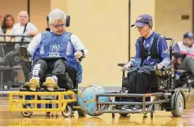  ?? Elizabeth Conley/Staff photograph­er ?? Adrián Sánchez, left, of Mexico’s Un Solo Equipo, and Chelsea Martinez of the Houston Fireballs compete in power wheelchair soccer on Saturday in Houston.