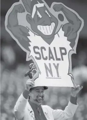  ??  ?? An avid Indians fan displays a Chief Wahoo sign before an American League postseason game in Cleveland in October 1997. Tony Dejak, Associated Press file