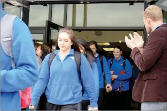  ?? Graham Thomas/Herald-Leader ?? John Brown University women’s basketball players exit out the front doors of Bill George Arena and through a tunnel of fans as they departed for the NAIA National Tournament in Billings, Mont., on Monday morning. JBU plays at 7:15 p.m. Thursday against...