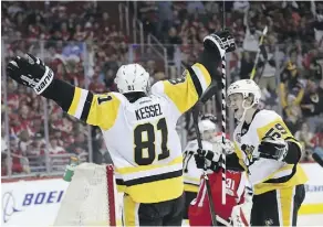  ?? ROB CARR/GETTY IMAGES ?? Pittsburgh Penguins right wing Phil Kessel celebrates with Jake Guentzel after scoring during Pittsburgh’s 6-2 win over Washington Capitals in Game 2 on Saturday in Washington, D.C.